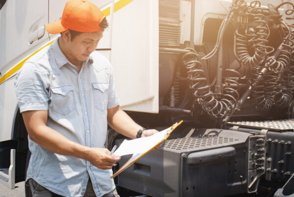 Man inspecting truck engine