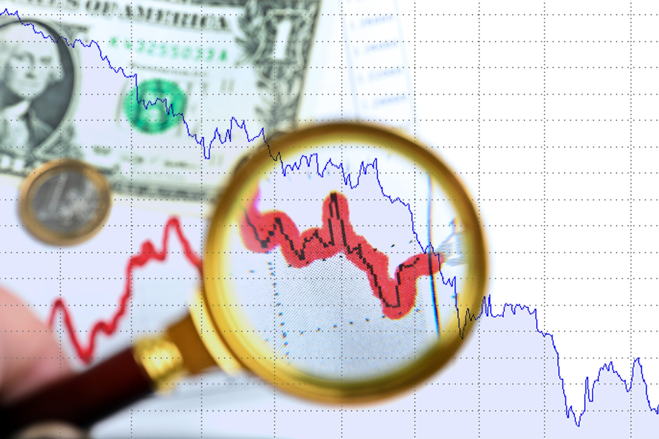 Magnifying glass over chart and money