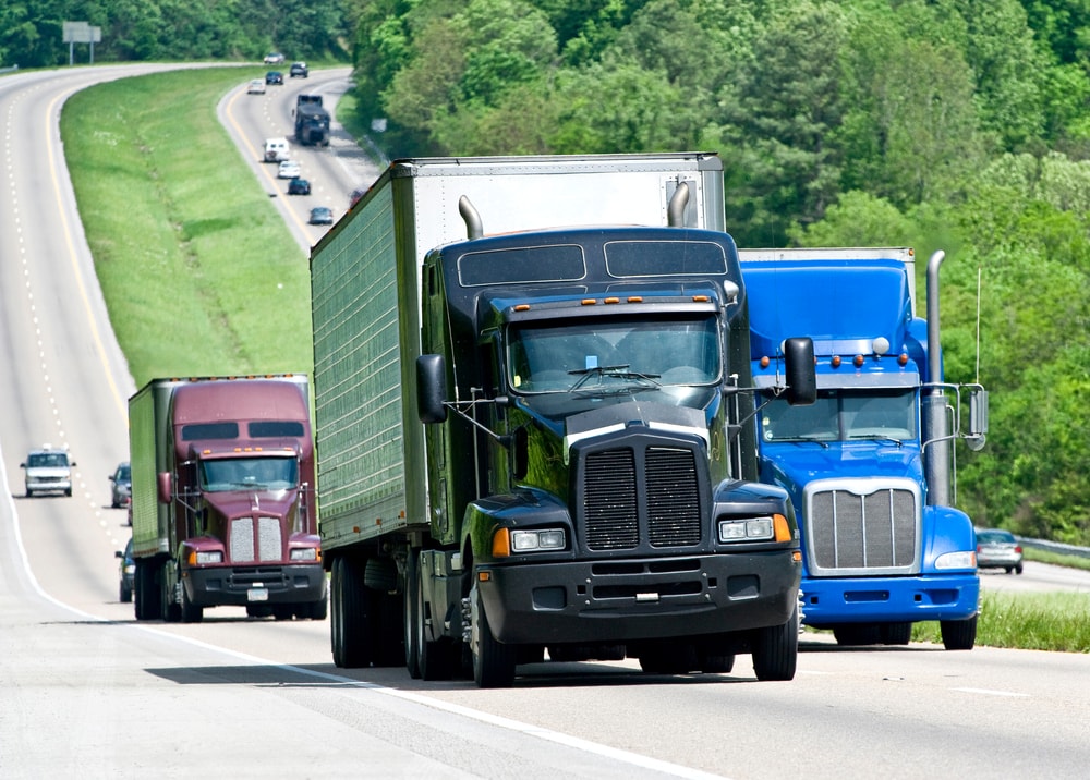 semi trucks driving down highway