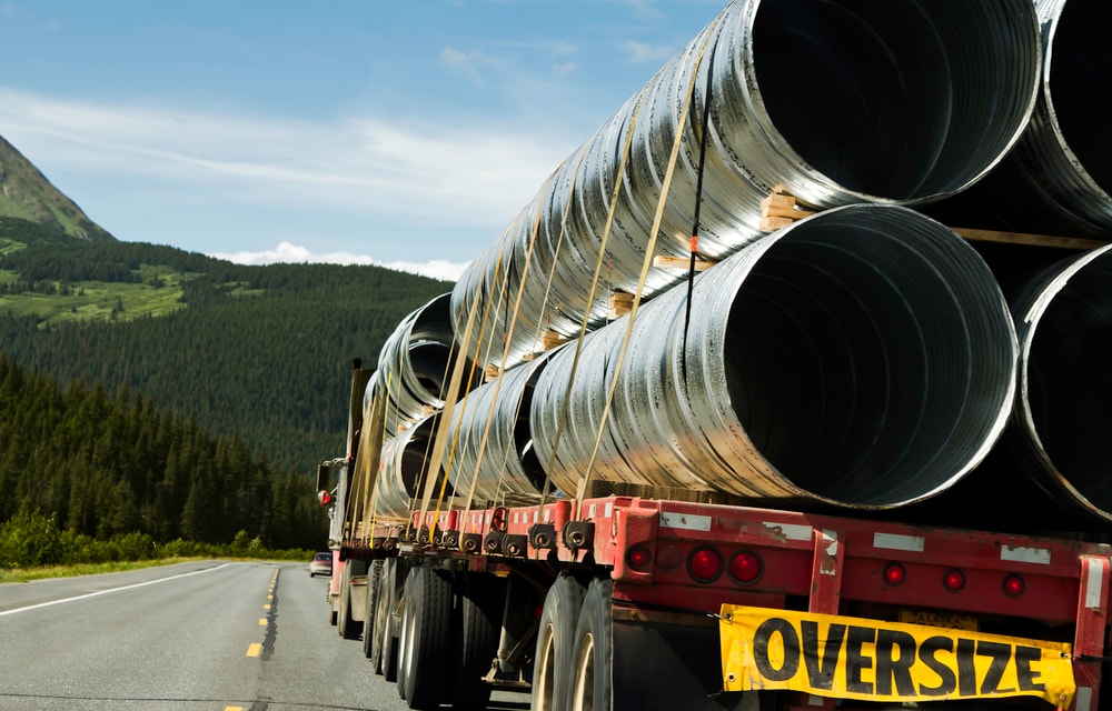 Flatbed trailer carrying oversized construction equipment