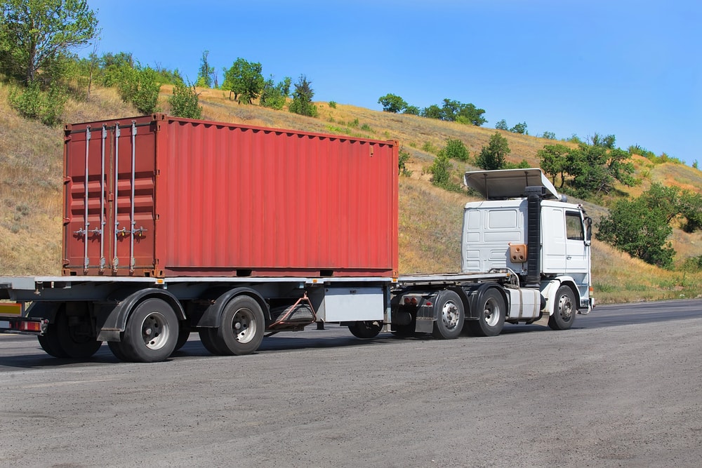 Side view of flatbed hauling container