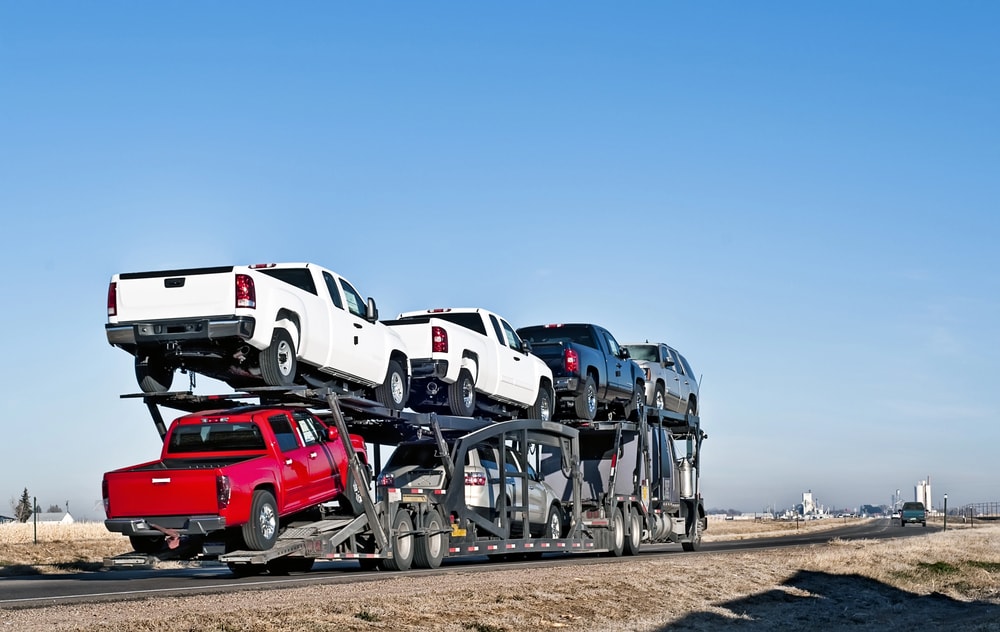 Trailer hauling cars and trucks