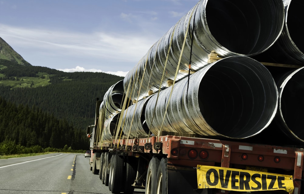 trailer hauling oversized load through mountains