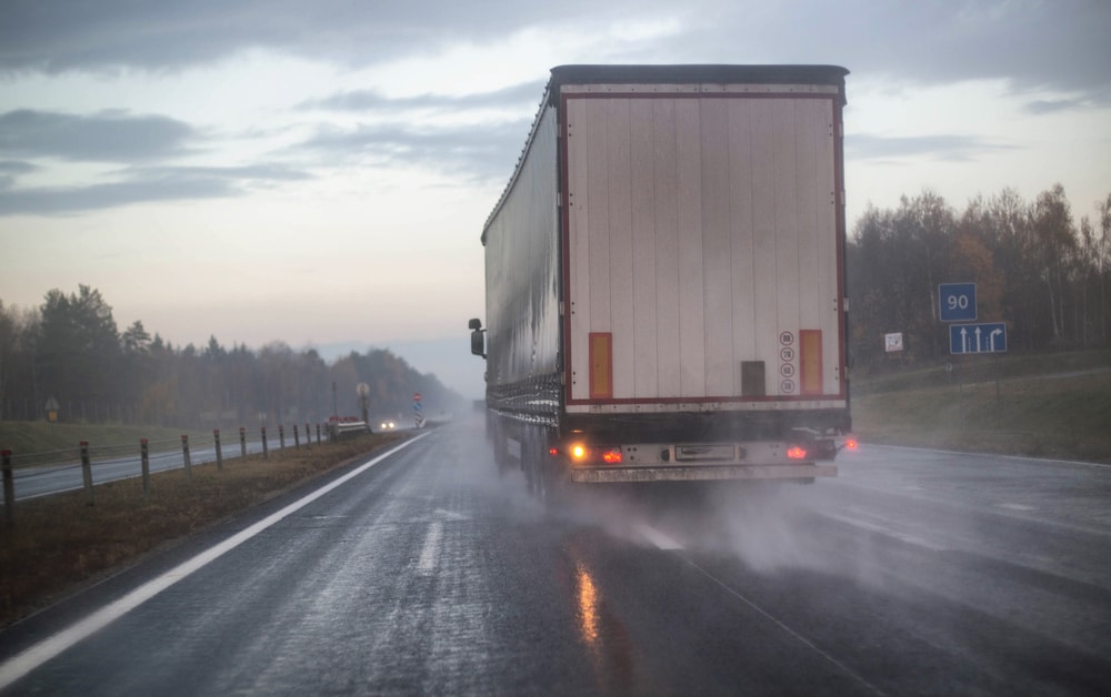 Truck on wet road with brake lights