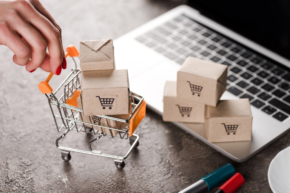 Shopping cart with boxes and a laptop