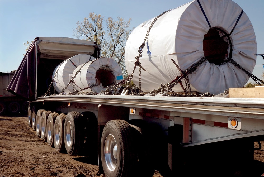 Conestoga trailer hauling large equipment