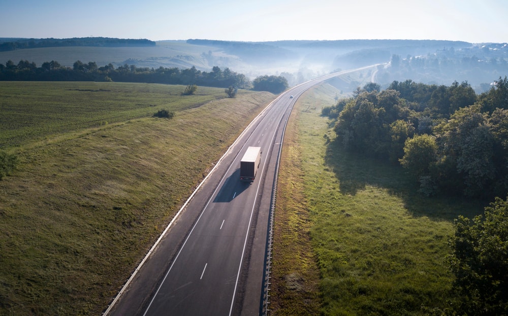 Tractor trailer driving down road