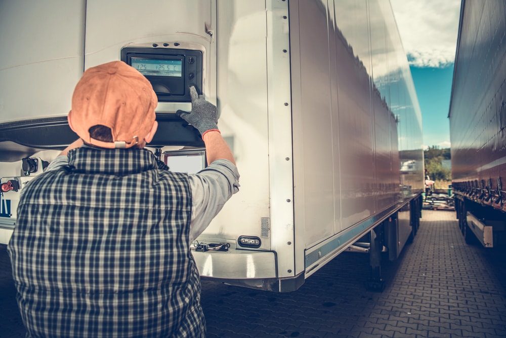 Trucker checking truck temp