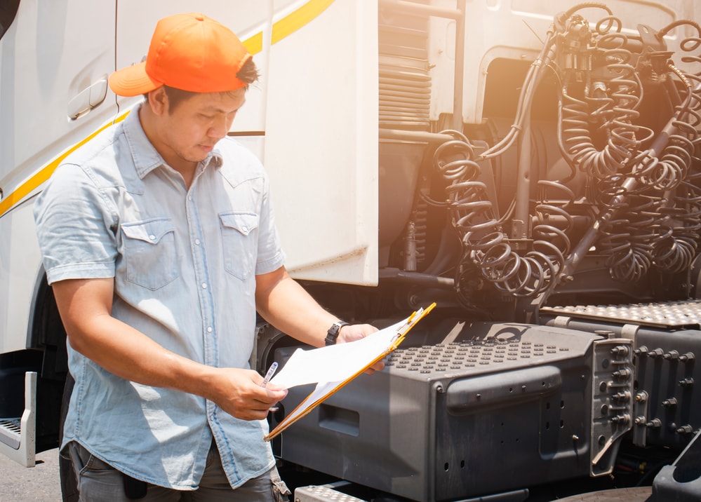 Man inspecting truck