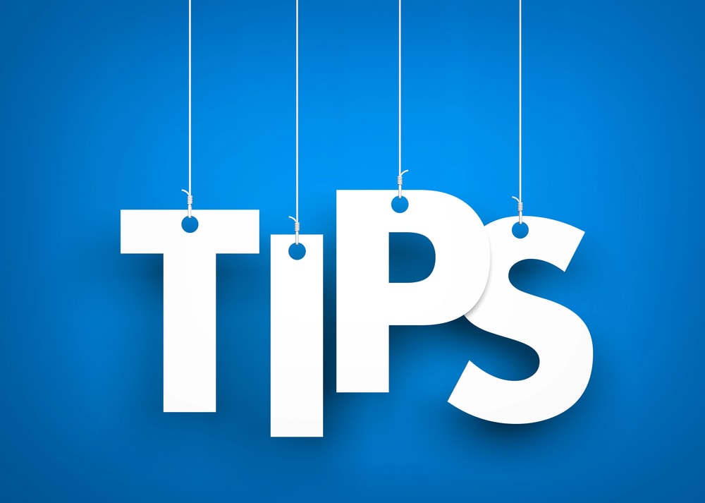 tips hanging from wire on blue background